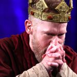 Dan Donohue as Macbeth, hands folded