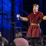 Dan Donohue as Macbeth, lifting a goblet