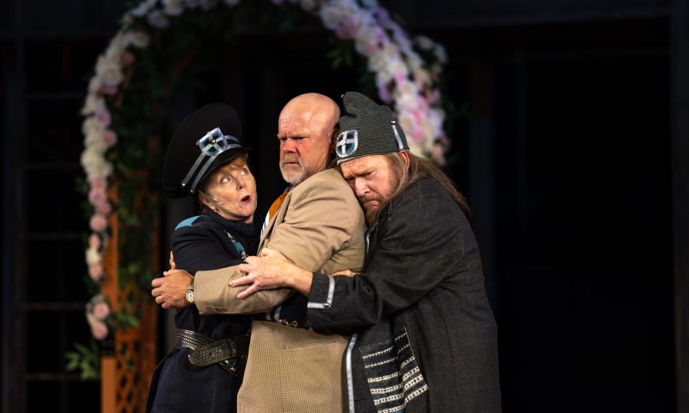 Patty Gallagher, Mike Ryan and Dan Donohue hugging eachother